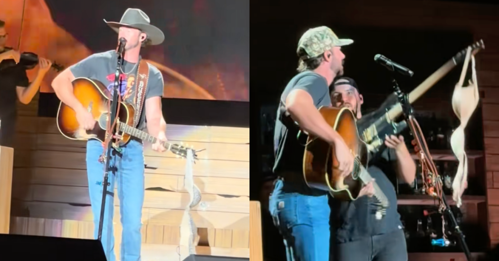 Riley Green Makes Fitting Lyric Change To Toby Keith’s “Should’ve Been A Cowboy” While Performing With A Bra Hanging From His Guitar